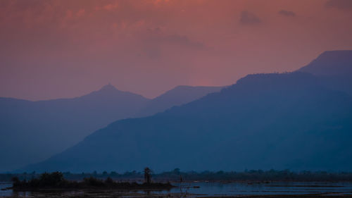 Scenic view of lake against sky during sunset