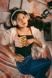 Portrait of a beautiful young woman sitting at home