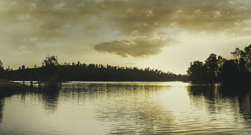 Scenic view of lake against sky during sunset