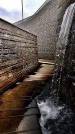 Water flowing on snow against sky