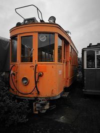 Train on railroad track in city against sky