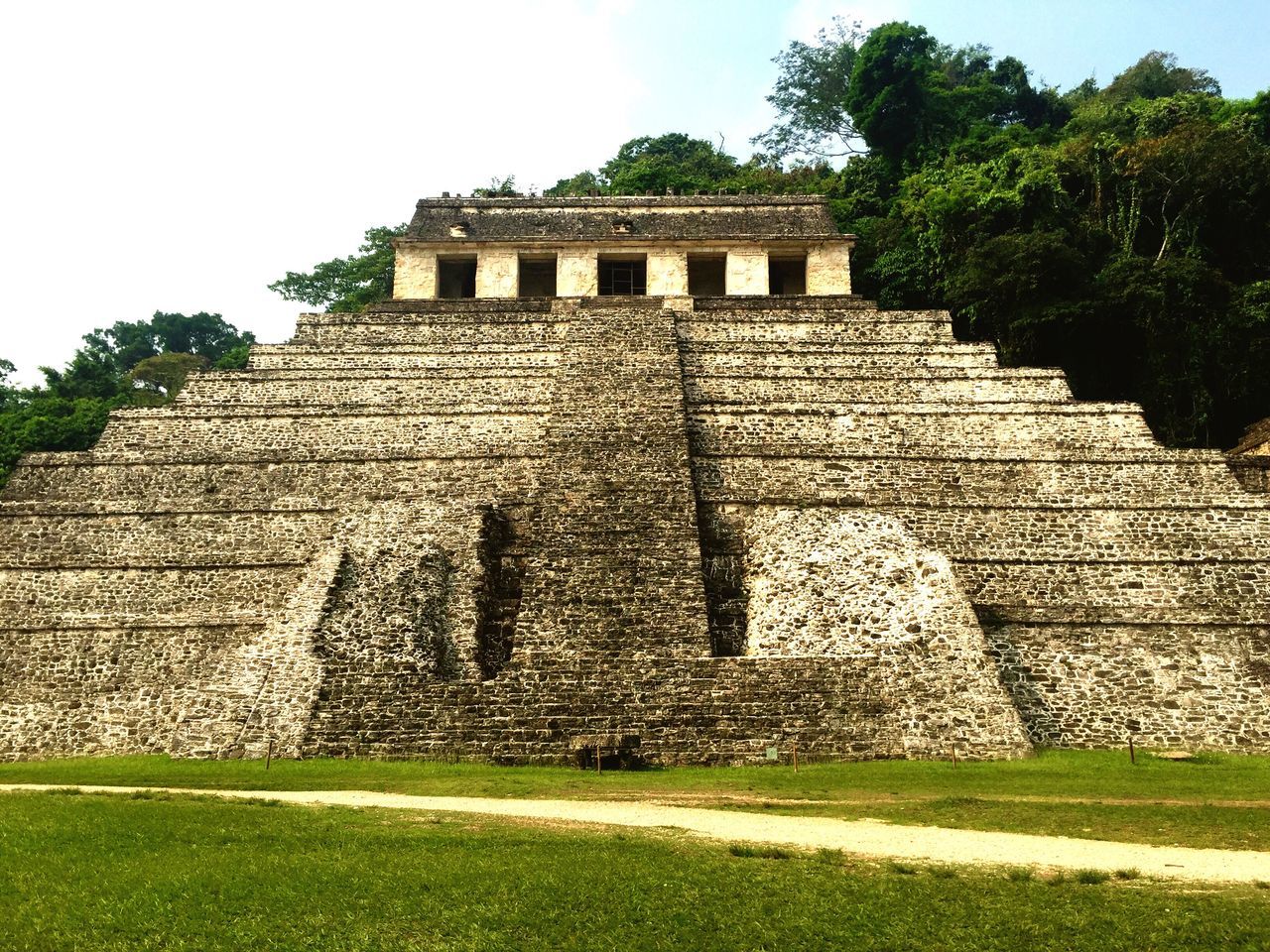 architecture, built structure, building exterior, history, low angle view, famous place, steps, ancient, clear sky, tree, travel destinations, grass, sky, the past, stone wall, travel, ancient civilization, old, tourism, old ruin