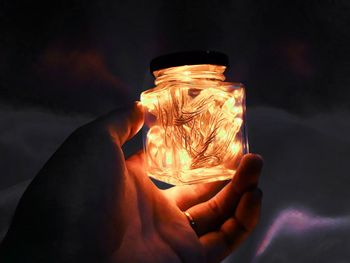 Midsection of person holding illuminated light