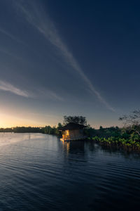 Scenic view of lake by building against sky