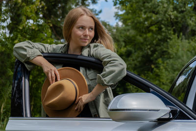 Portrait of young woman driving car