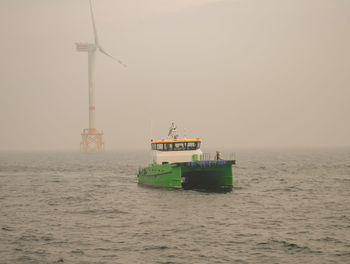 Boat sailing on sea against sky