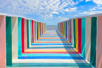 Multi colored staircase against blue sky
