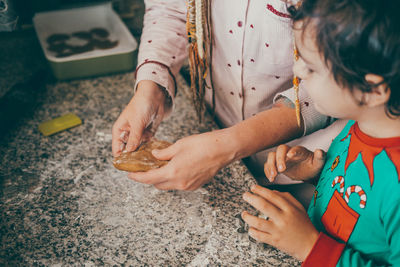 Holiday joy is in the air as a cheerful mom and son in the kitchen, creating christmas gingerbread