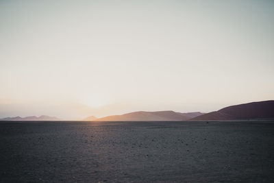 Scenic view of mountains against clear sky during sunset