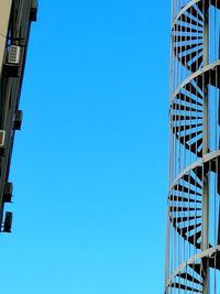 Low angle view of modern building against blue sky