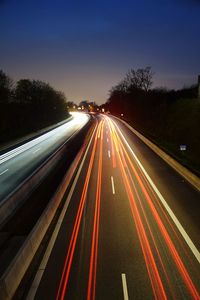 High angle view of light trails on road at night