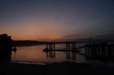 Silhouette pier on sea against sky during sunset