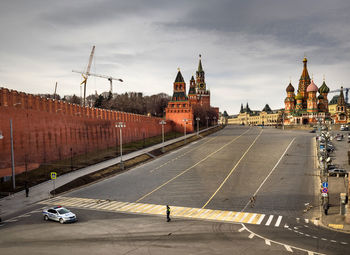 City street by st basils cathedral against sky at kremlin