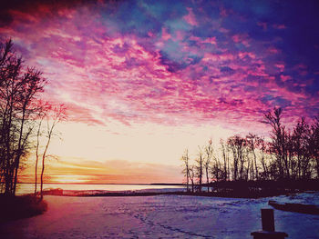 Scenic view of snow covered landscape during sunset