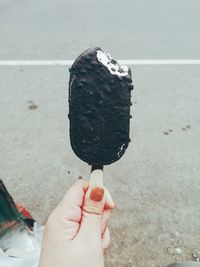 Cropped hand holding ice cream cone