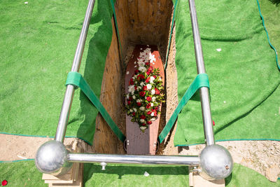 Closeup shot of a funeral casket or coffin in a hearse or chapel or burial at cemetery
