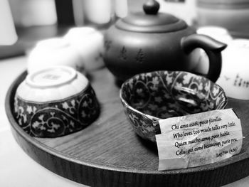 Close-up of tea with text in tray on table