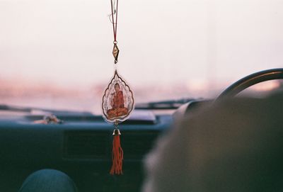 Close-up of decorative hanging in car