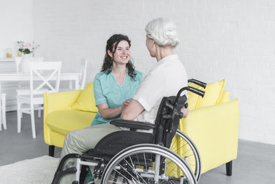 Women sitting on the wall of people