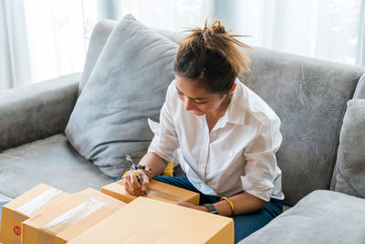 Woman working on sofa