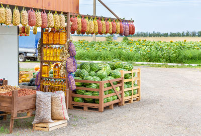 Roadside farmers market selling eco foodstuffs against the background of a field with sunflowers. 