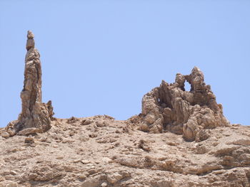 Low angle view of rock formation against clear sky