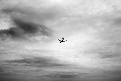 Low angle view of airplane flying in sky