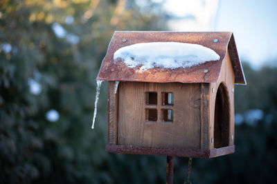 Close-up of birdhouse on wood