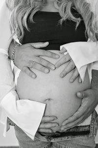 Cropped image of beautiful pregnant woman and her husband.