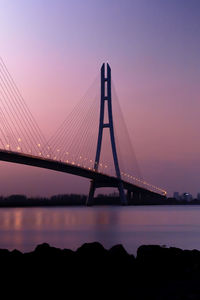 Low angle view of suspension bridge against sky