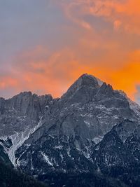 Scenic view of snowcapped mountains against sky during sunset