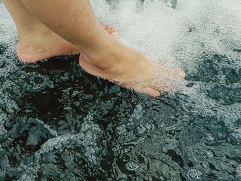 Low section of woman in sea