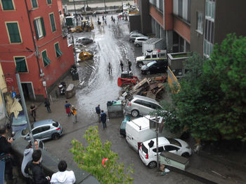 High angle view of vehicles on road along buildings