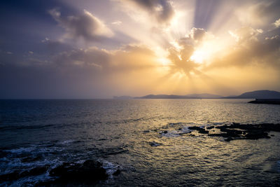 Sunrays over seat at sunset in sardinia