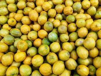 Green and yellow lemons at market