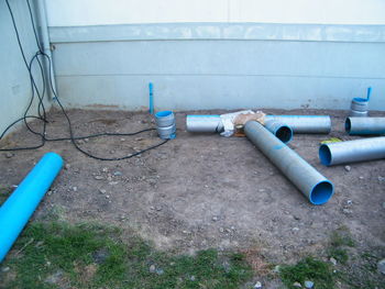 High angle view of pipes on floor against wall