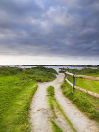 Storm clouds over dirt road