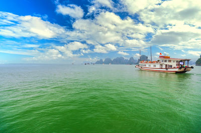 Boat sailing in sea against sky