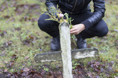 Man with flowers on graveyard, skogskyrkogarden, stockholm, sweden