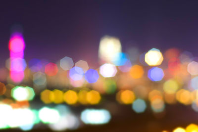 Defocused image of illuminated city at night