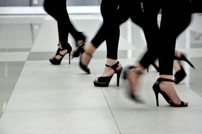 Low section view of women wearing high heel sandal
