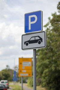 Road sign against sky