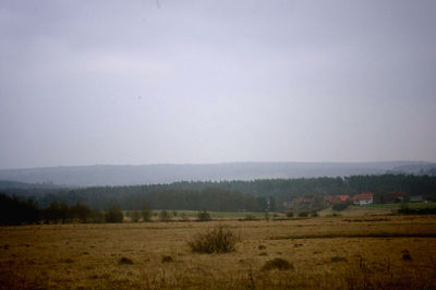 Scenic view of field against cloudy sky