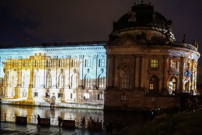 Reflection of building in water at night