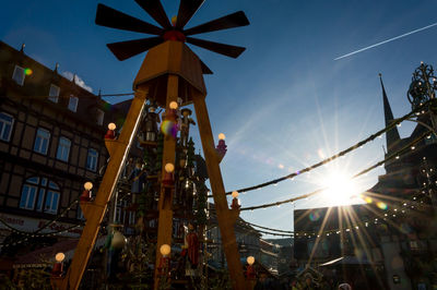 Low angle view of ferris wheel in city