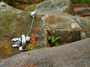 Iron twisted rope streched between rocks for climbers. rope fixed in block by screws snap hooks. 