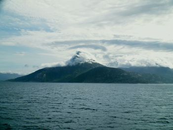 Scenic view of sea and mountains against sky