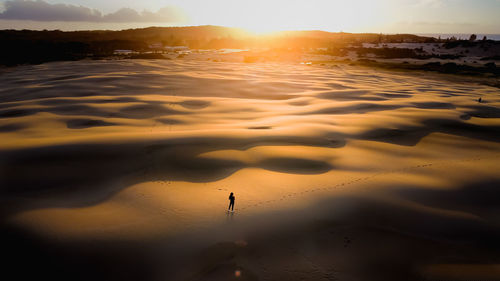 Scenic view of beach against sky during sunset