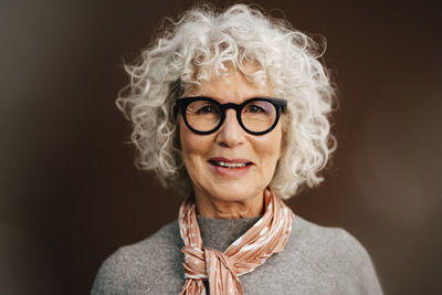 Portrait of senior woman wearing eyeglasses in studio