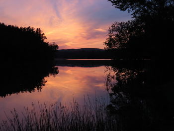 Scenic view of calm lake at sunset